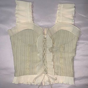 Ruffle blouse with lace up detail